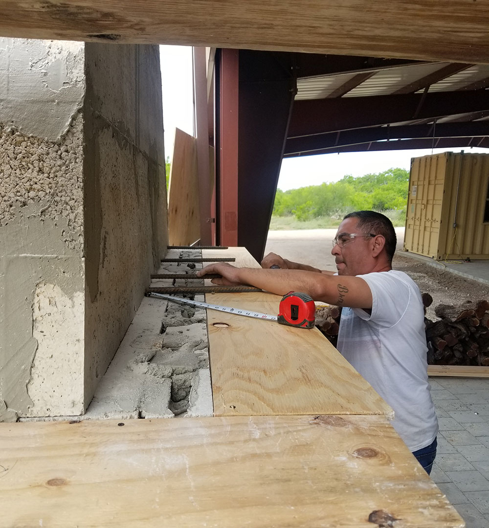 Coastal Masonry team building an outdoor fireplace. 