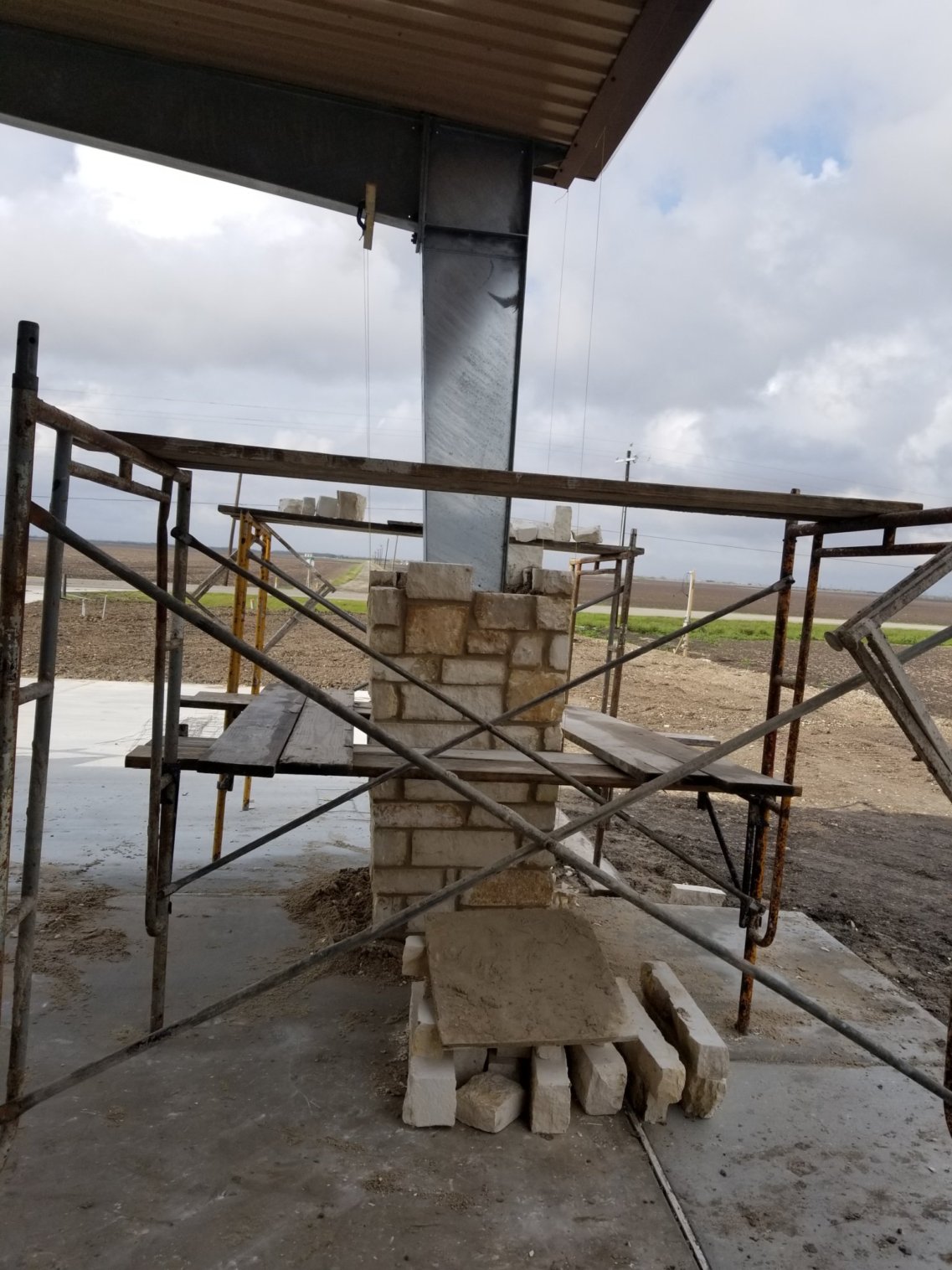 Masonry contractors building pillars. 