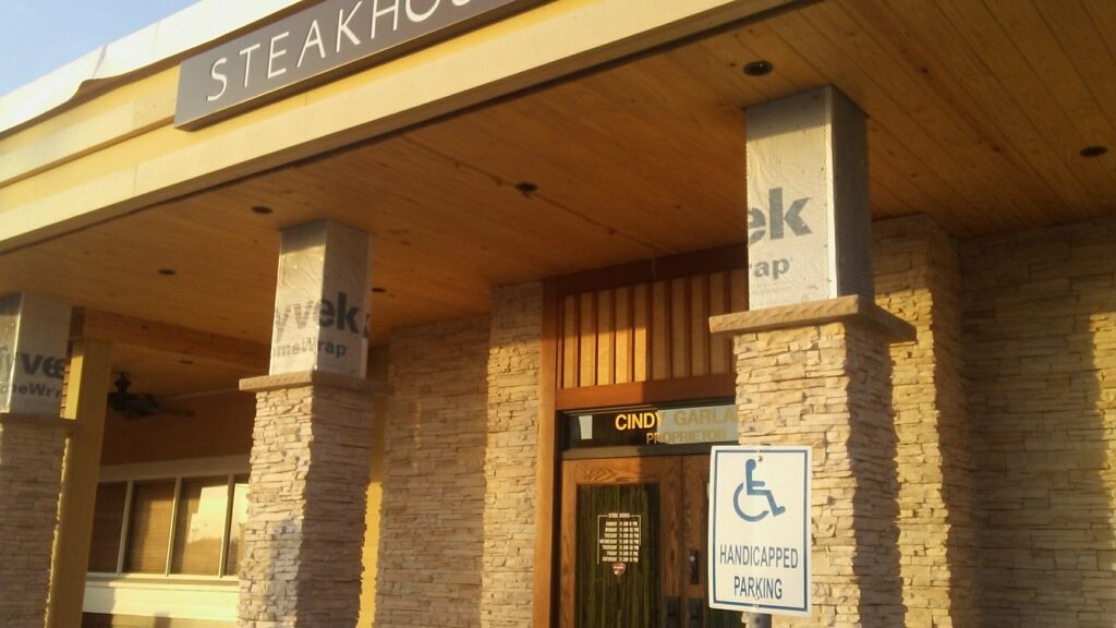 Masonry contractors work on steakhouse. 